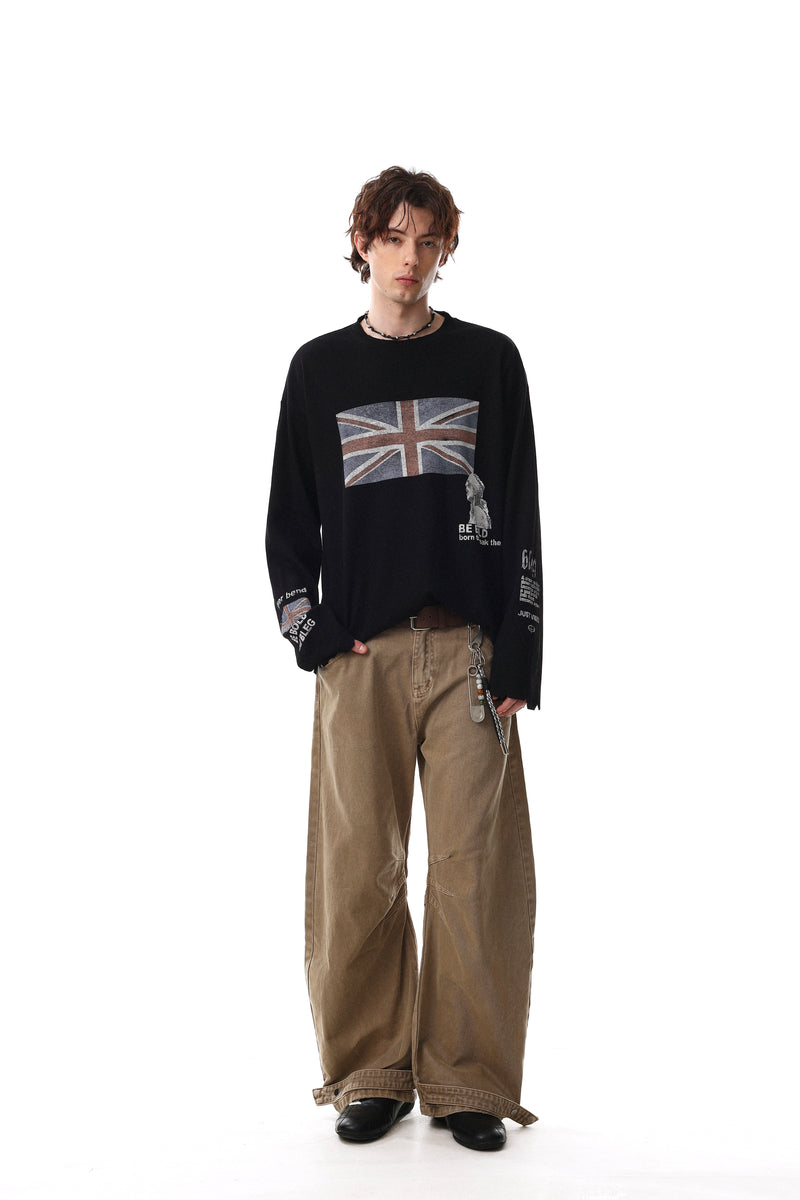 Black long sleeve tee on model, front view with Union Jack graphic and wide brown pants