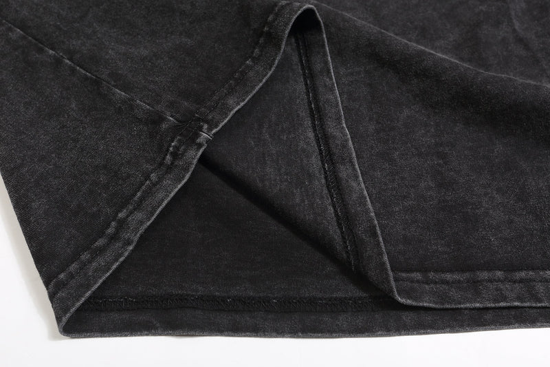 Close-up of black hem and sleeve seam on distressed sweatshirt fabric