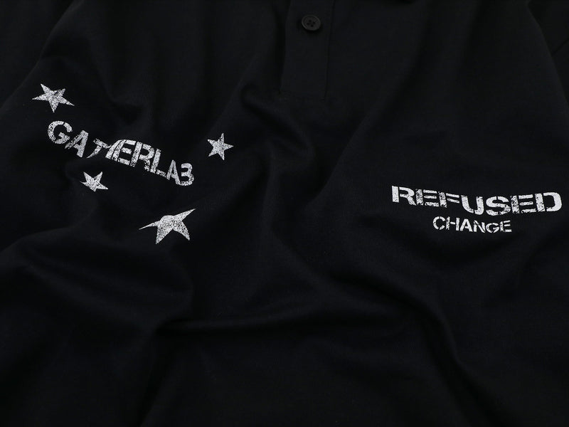 Close-up of front chest graphics on black polo with stars and white text