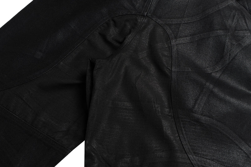 Close-up of black pants crotch and thigh panel stitching