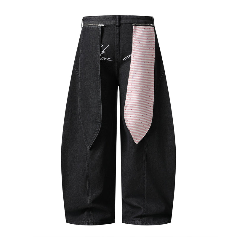 Black wide-leg jeans with pink striped front panel and script detail, front view