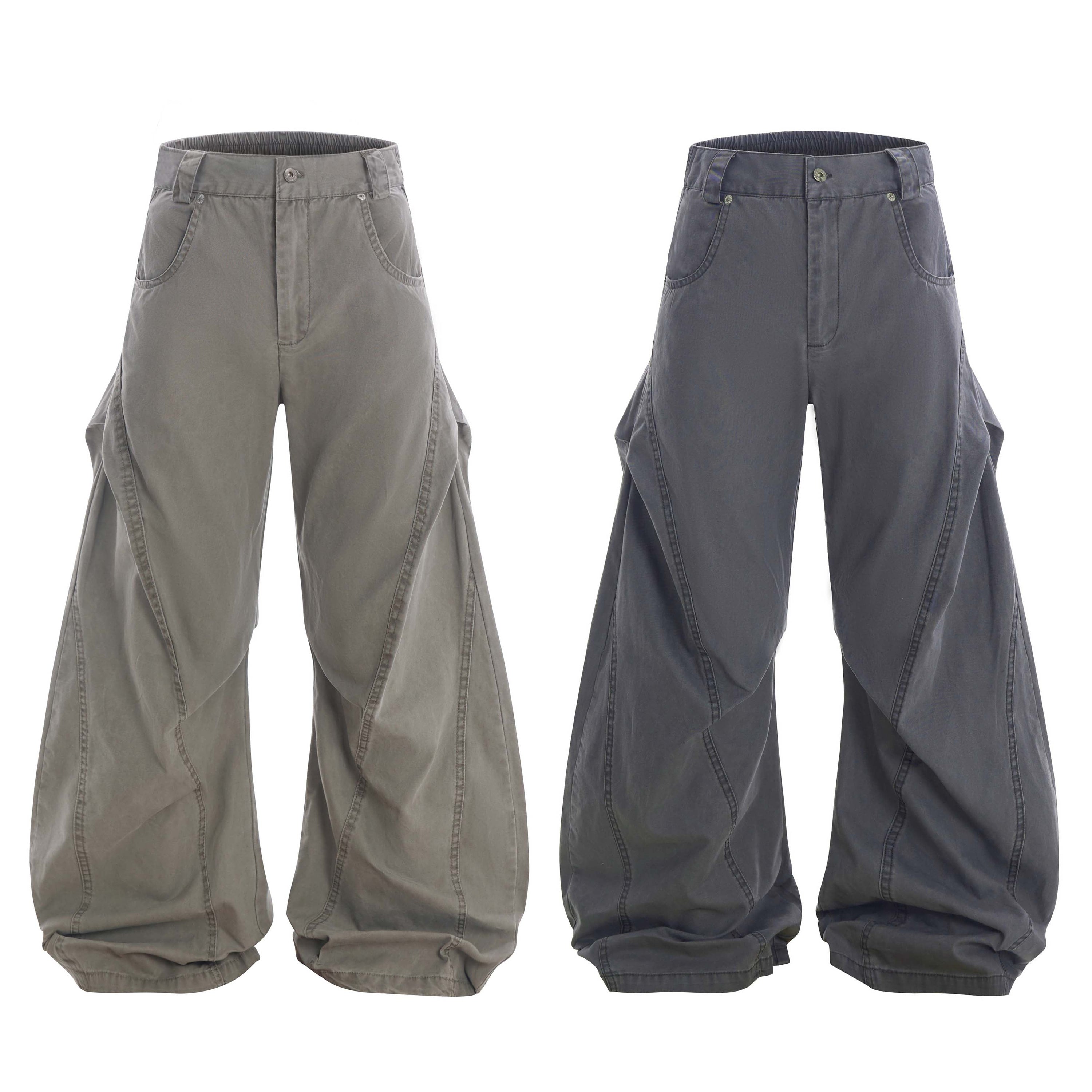 Two pairs of oversized washed wide-leg pants with curved seam detailing shown side by side in olive grey and charcoal