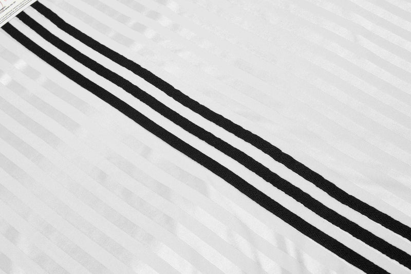 White football jersey fabric with three bold black diagonal stripes and subtle textured weave detail