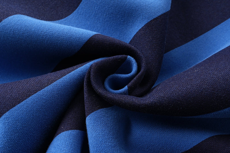Close-up of folded blue and navy striped fabric texture