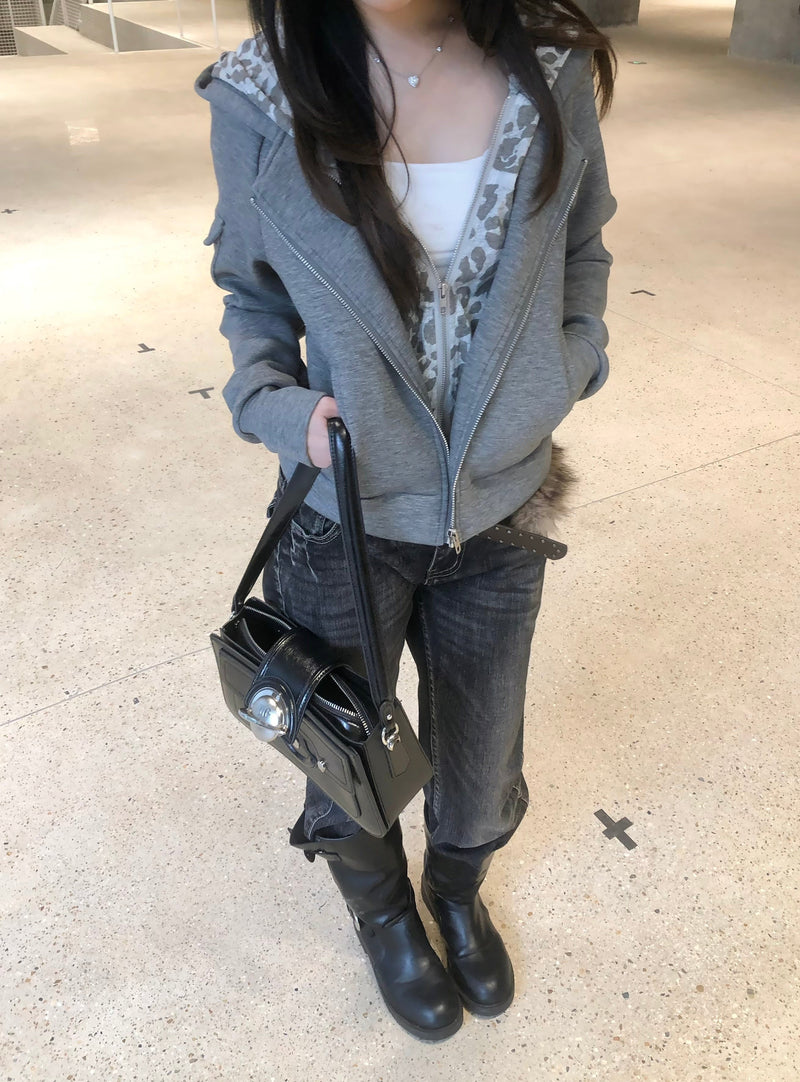 Grey zip-up hoodie on model, front view with hood lining visible