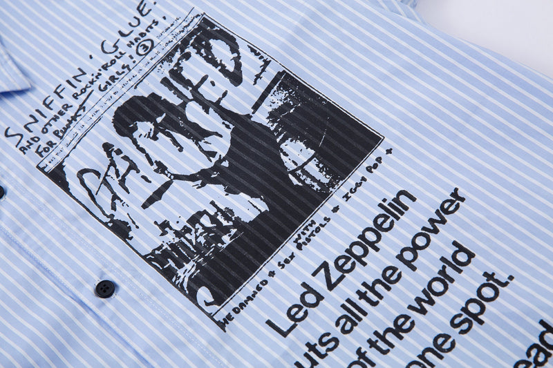 Close-up of front graphic on light blue pinstripe shirt with black button detail