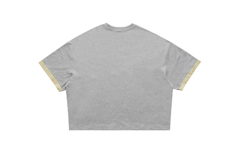 Gray cropped varsity graphic tee with short sleeves and beige cuff trim, shown flat on a white background