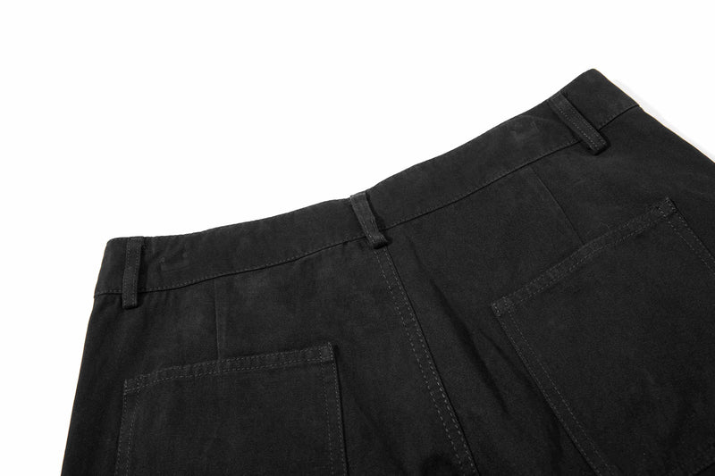 Black shorts waistband and pocket detail, angled close-up