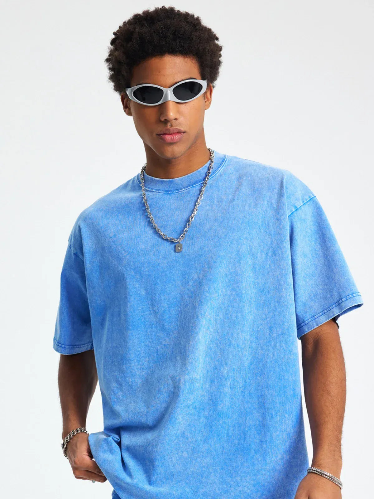 A person wearing white sunglasses, a silver chain necklace, and a Custom Anime Character Blue Washed T-Shirt - Personalized Anime Style Tee stands against a plain light background.