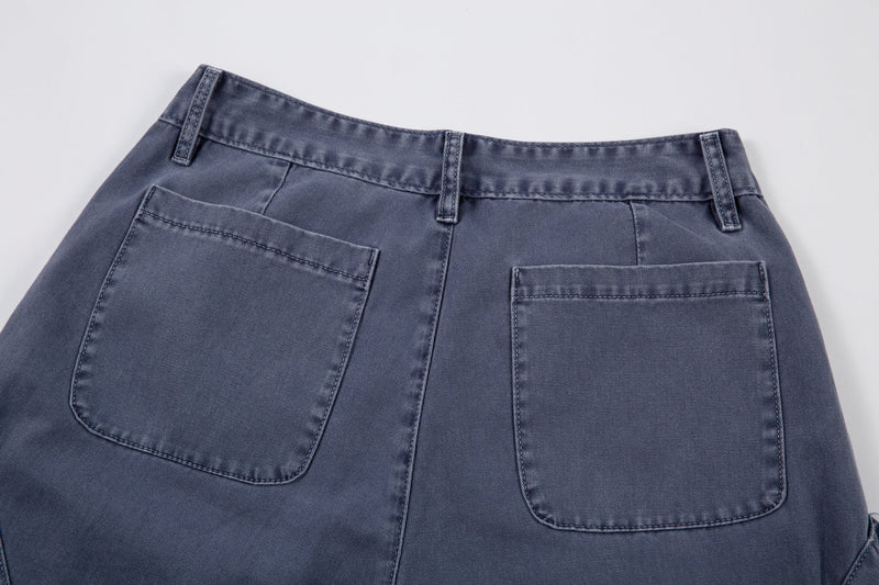 Back waistband close-up showing two patch pockets on blue denim pants