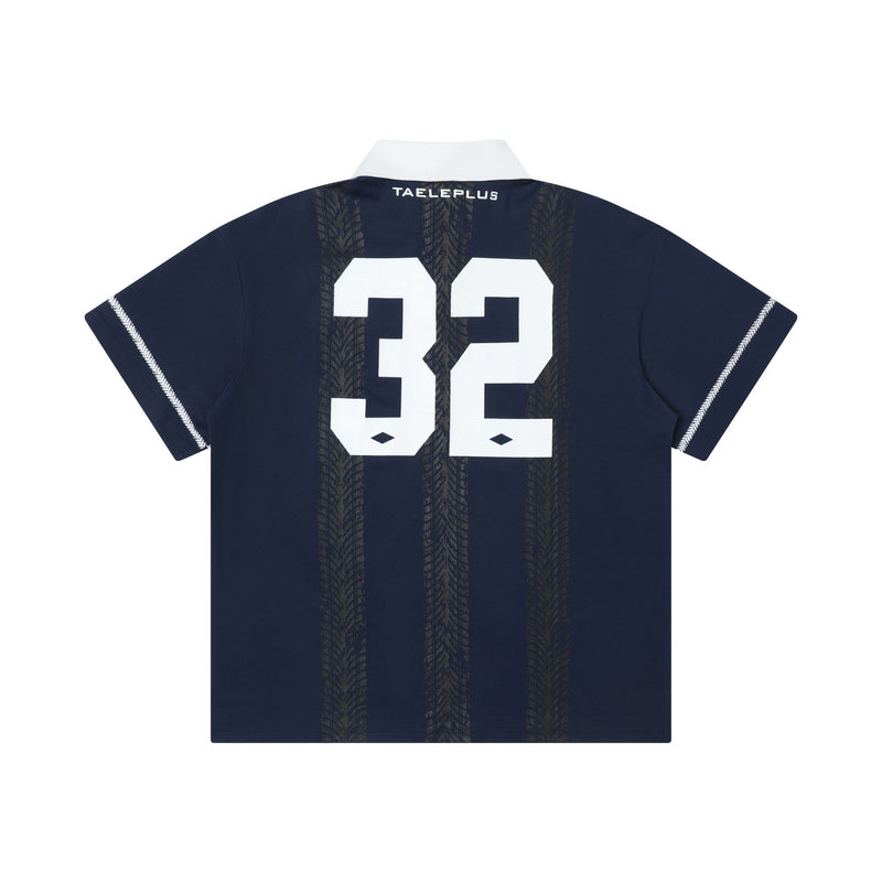 Navy retro soccer polo shirt with white collar, large 32 print, and subtle vertical tire-tread stripe graphics on the back