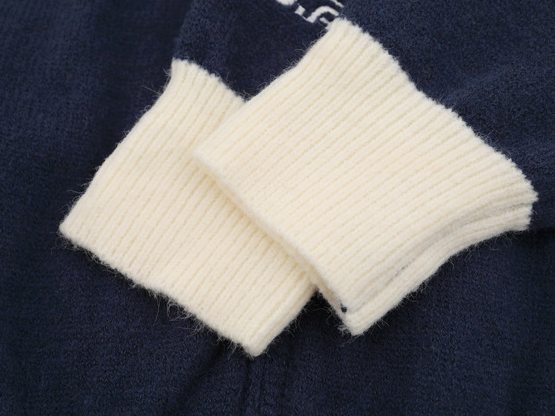 Close-up of cream ribbed sleeve cuffs on the varsity knit jacket
