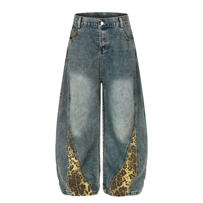 Front view of blue washed wide-leg denim jeans with leopard-print panels at the hem