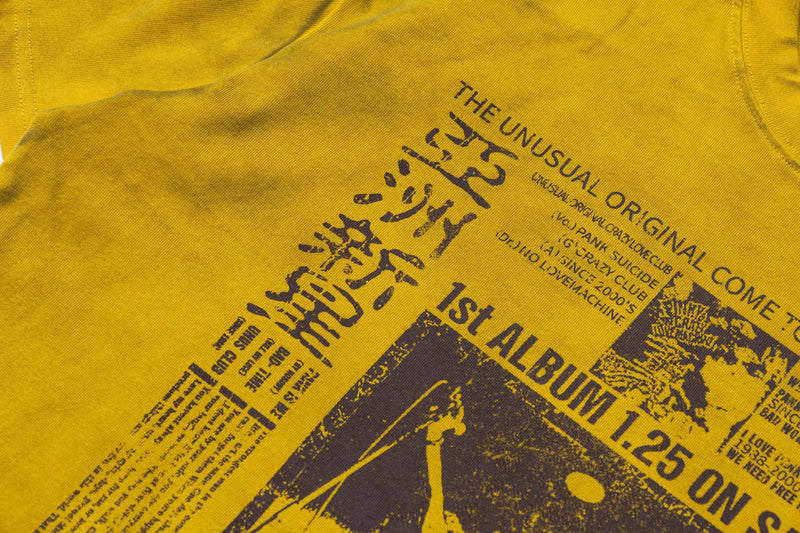 Yellow vintage washed tee with bold black punk-style retro graphics and distressed typography print