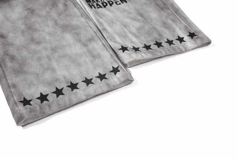 Close-up of pant legs with black star print near the hem