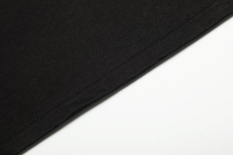 Close-up of black tee hem with stitched edge