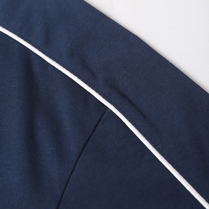 Navy cotton tee with white contrast piping and a close-up view of the shoulder seam and sleeve detail