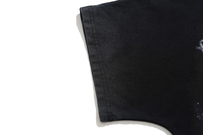 Black vintage-washed oversized graphic tee sleeve with faded distressed detailing on a white background