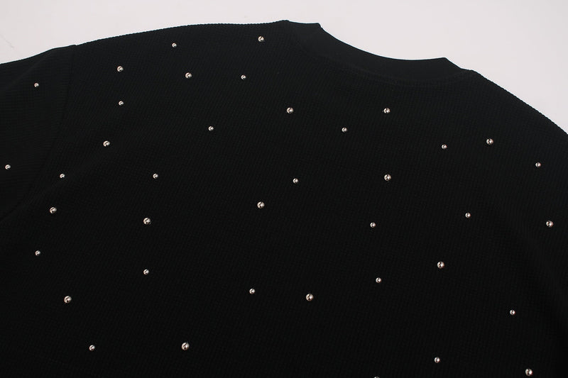 Black oversized T-shirt with scattered rhinestone embellishments on a ribbed knit fabric, shown flat lay