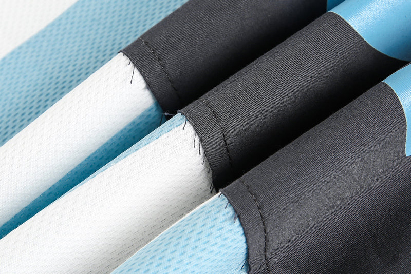 Close-up of sleeve cuffs and seam stitching on red, white, and light blue tee