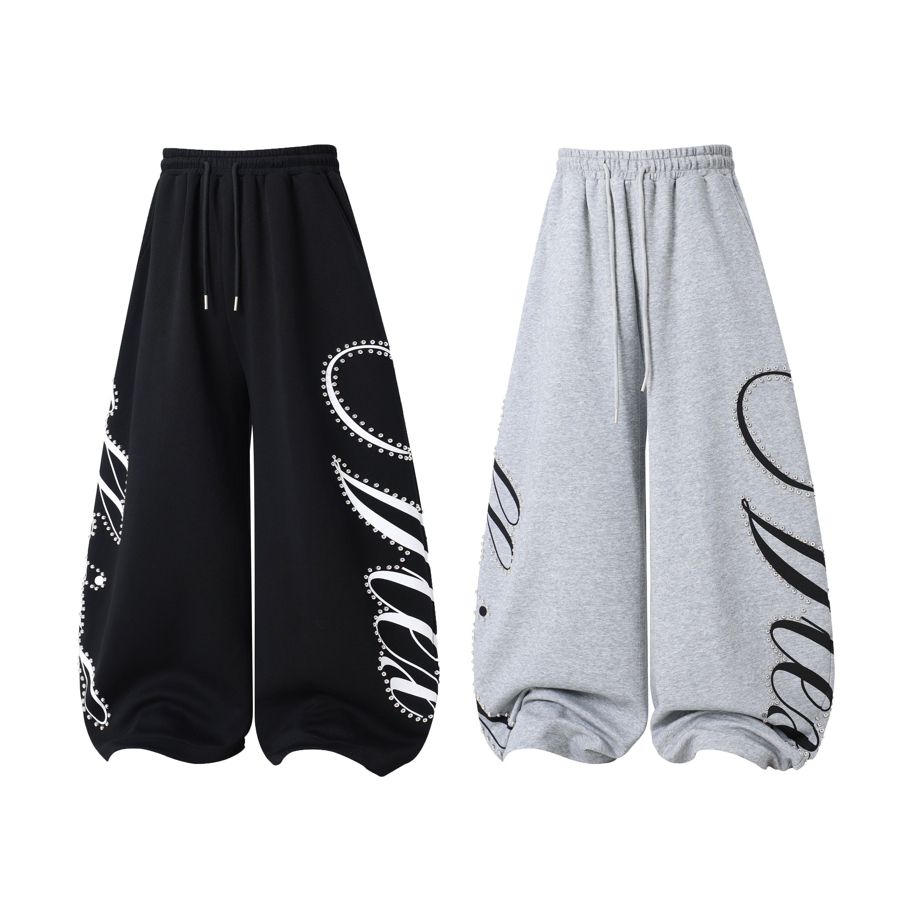 Omirad Studded Script Sweatpants in black with oversized wide-leg fit and white metallic stud script graphic design