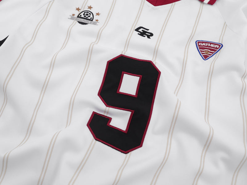 Close-up of white pinstripe jersey front showing number 9 and chest patches
