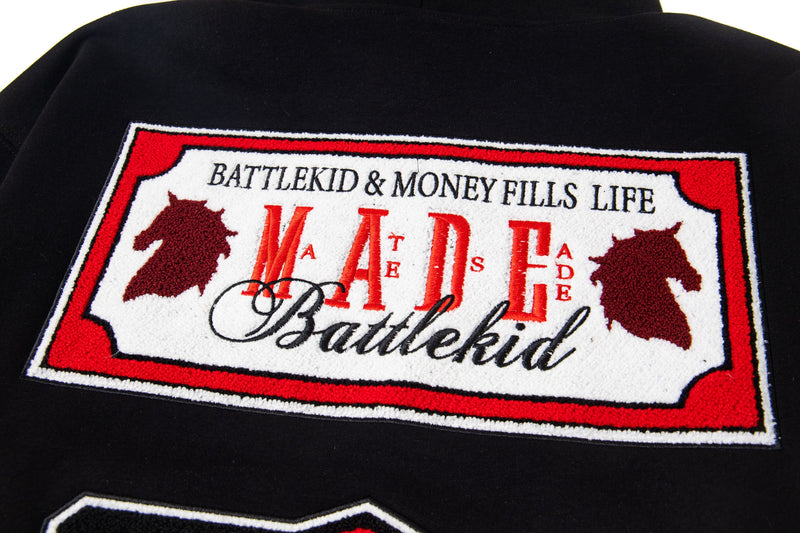 Black hoodie back close-up of upper embroidered MADE badge graphic