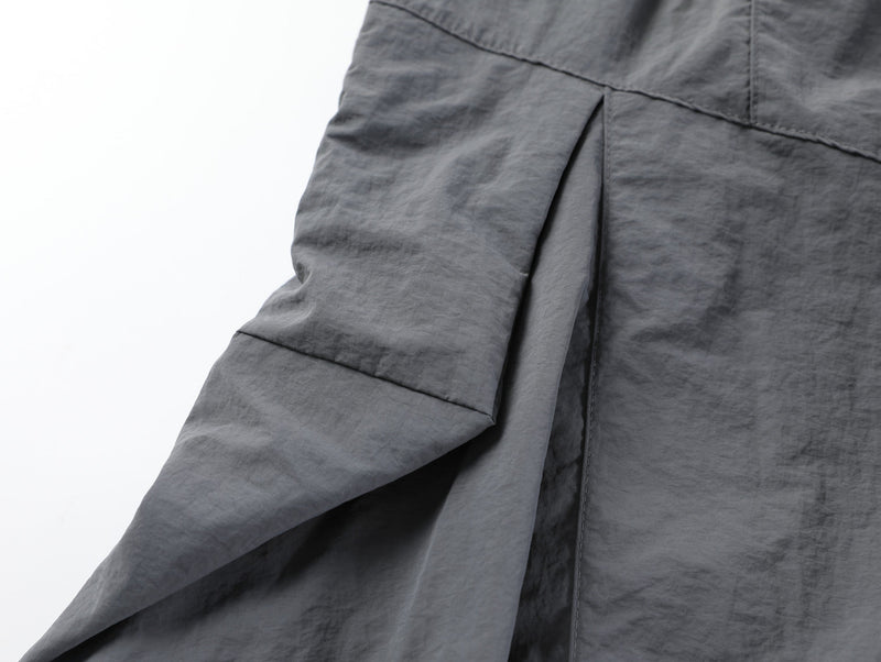 Close-up of gray shorts front panel and seam detail near the crotch