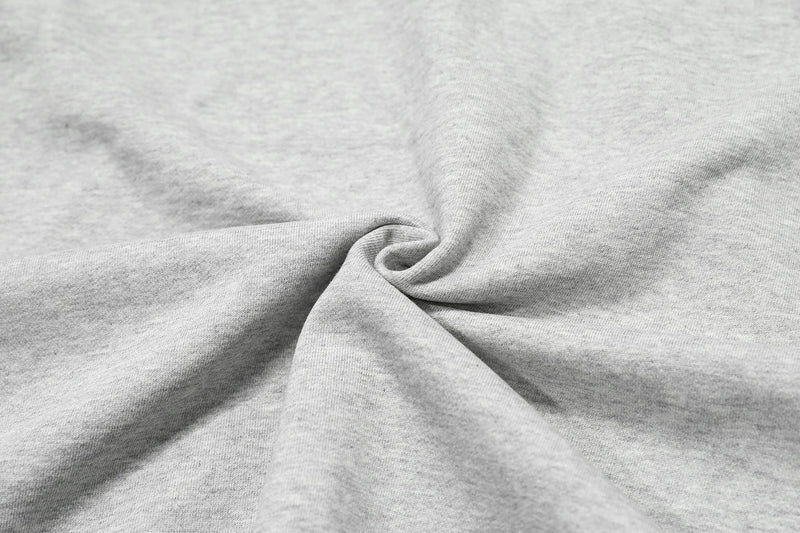 Close-up of light gray hoodie fabric texture with soft folds