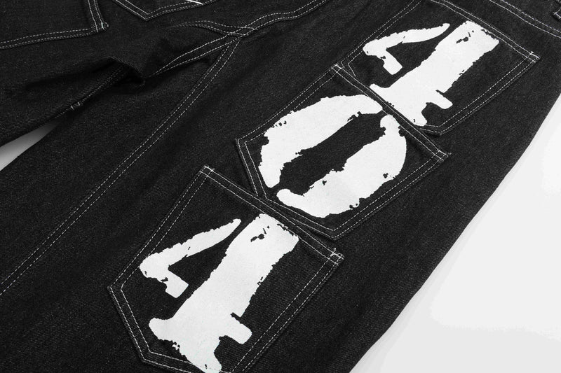 Back pocket area of black denim shorts with large white printed patches