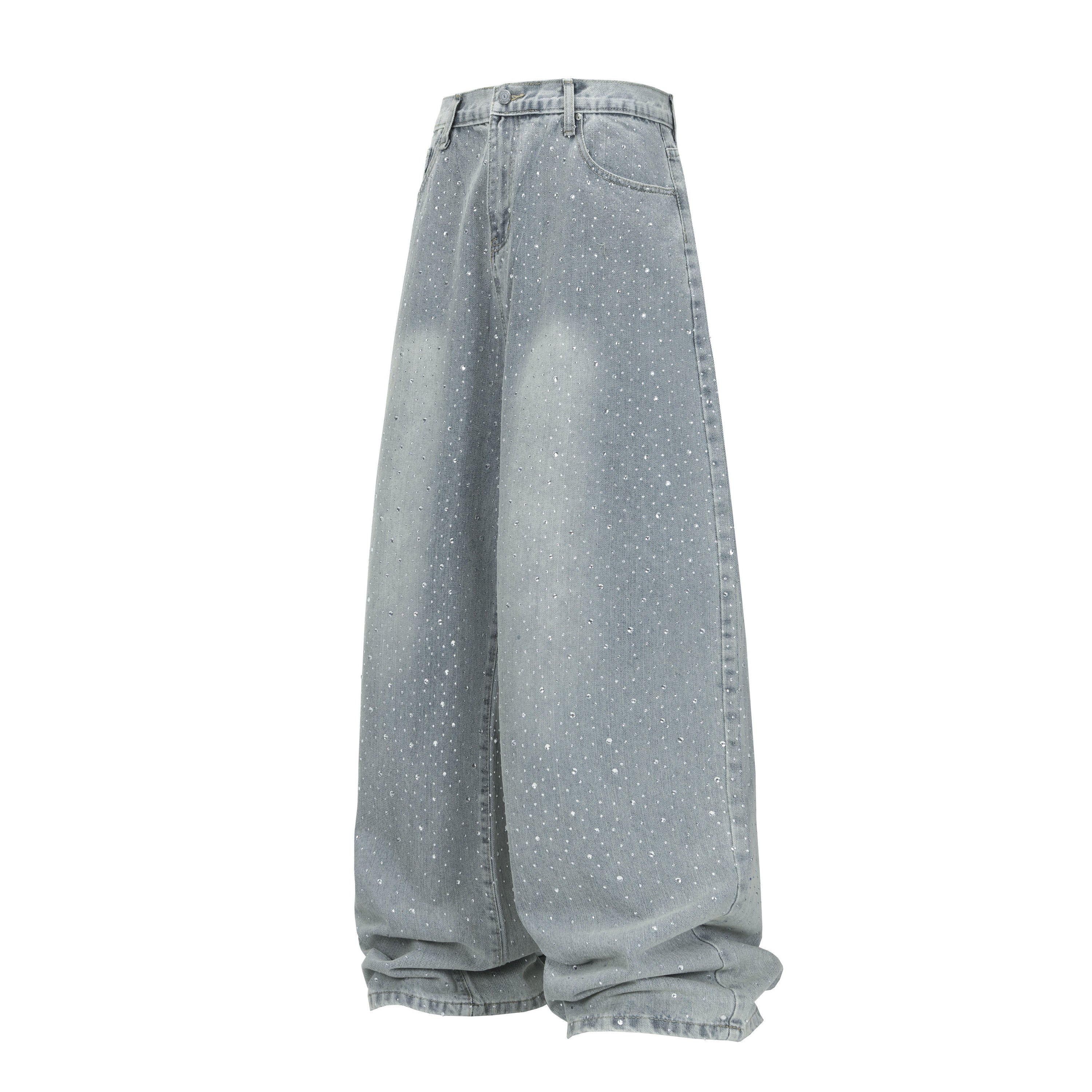 Light-wash wide-leg jeans with all-over rhinestone scatter and stacked hem effect, shown from a side angle