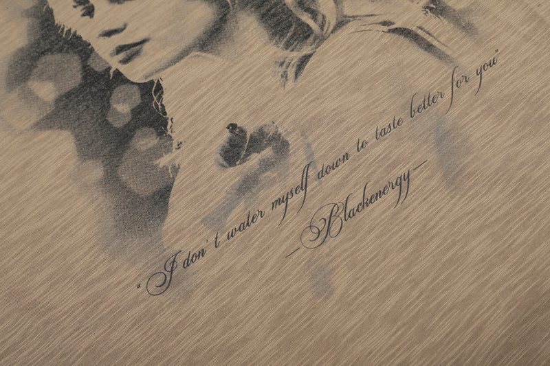 Close-up of faded script text on brown portrait graphic tee