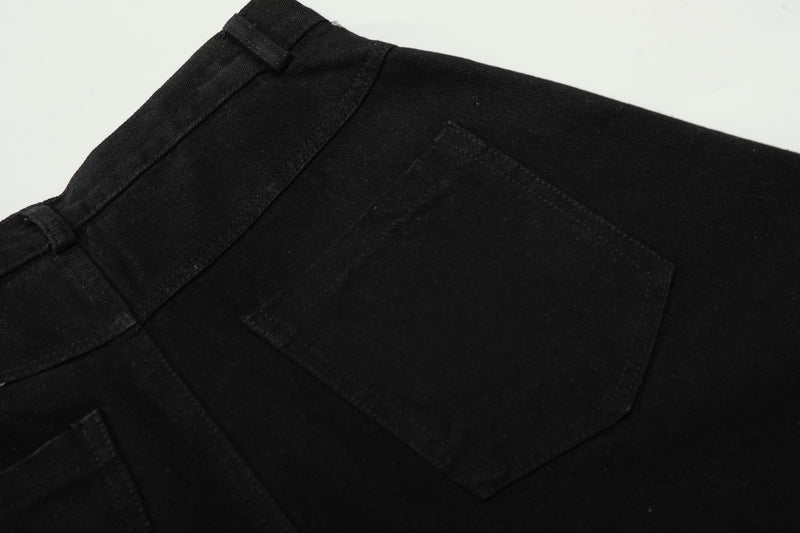 Close-up of back pocket stitching on black pants