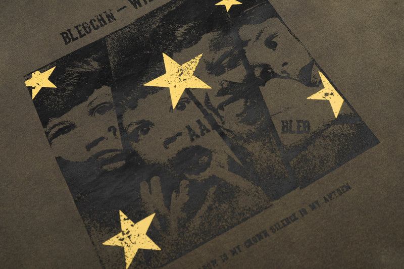 Vintage washed streetwear tee with black graphic portrait collage and distressed yellow stars on olive fabric