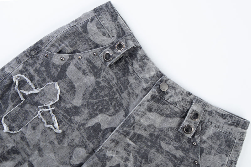 Close-up of gray distressed camo pants waistband and upper pocket details