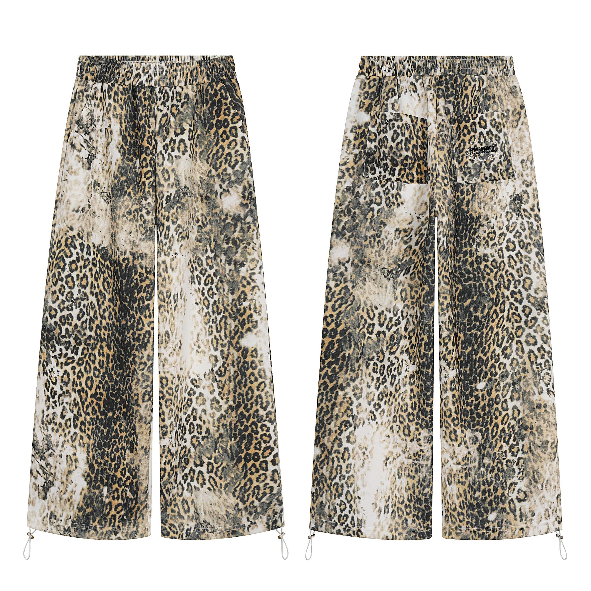 Front and back view of wide-leg leopard print pants with vintage wash effect, elastic waistband, and drawcord hems