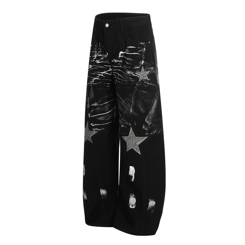 Black wide-leg jeans with brush-stroke print and star patch details, angled front view