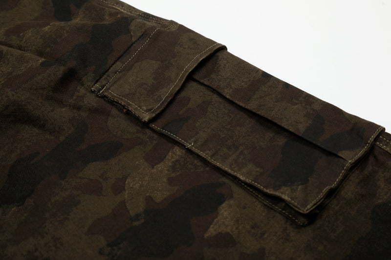 Close-up of cargo pocket flap on camouflage shorts with stitched trim