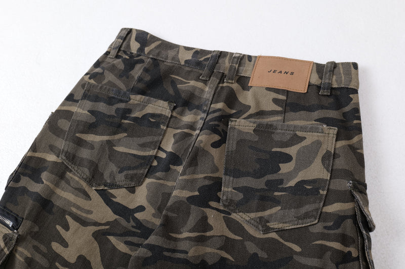 Close-up of front waistband on camo cargo pants with tan JEANS label