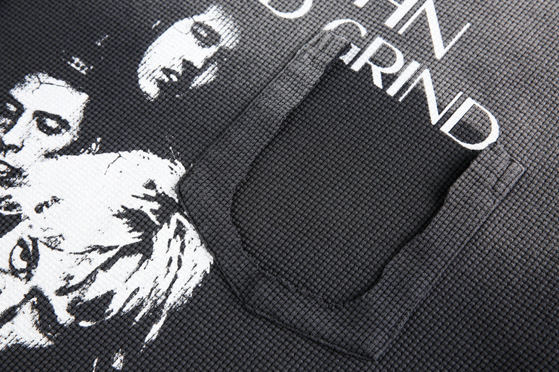 Close-up of printed faces and Rise and Grind text on black waffle knit tee