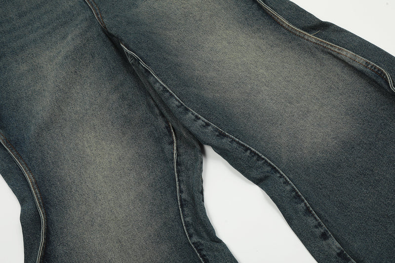 Close-up of faded blue denim leg with outer seam and subtle whiskering