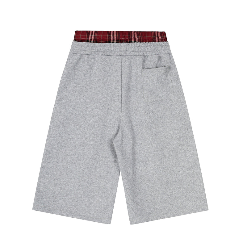 Back view of gray shorts with red plaid waistband and single back pocket