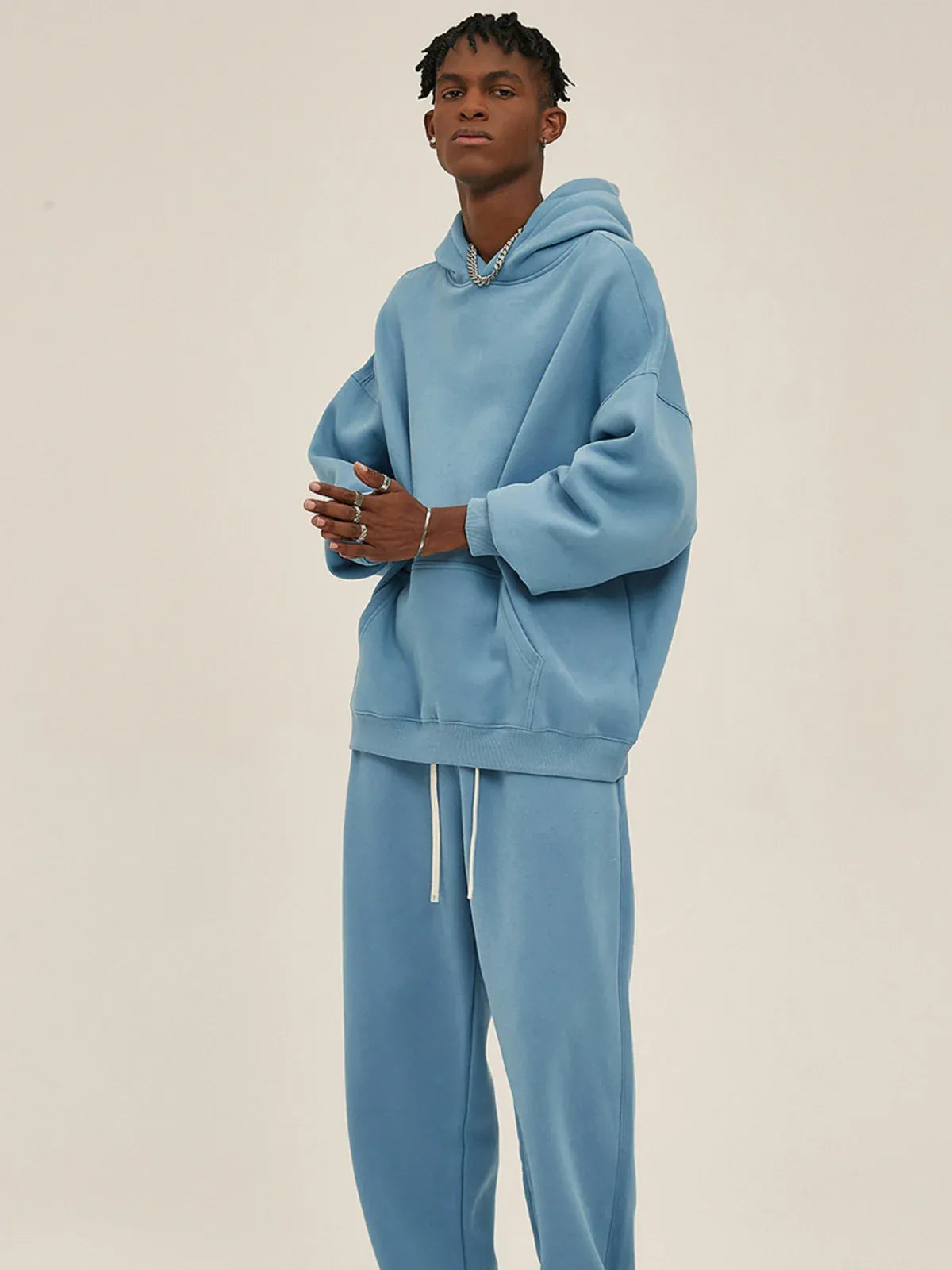 A person stands against a plain background wearing a Custom Anime Character Sky Blue Hoodie—Personalized 350GSM 100% Cotton Pullover—and matching sweatpants.
