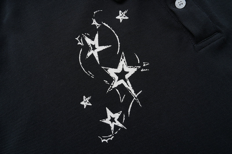 Black shirt front close-up showing scattered white star print near the chest and shoulder