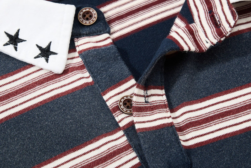 Close-up of a vintage striped rugby polo shirt with navy, burgundy, and white panels, star cuff detail, and buttons