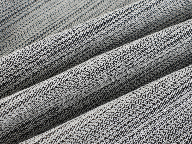 Close-up of gray woven fabric texture with raised diagonal folds