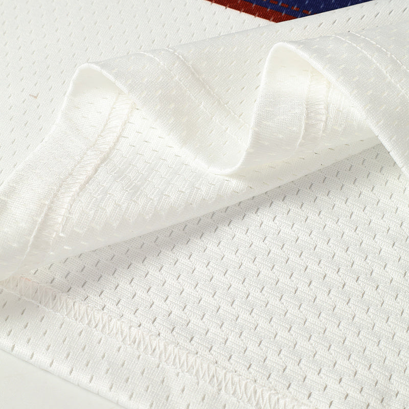 Close-up of a white mesh football jersey with breathable fabric and folded hem details