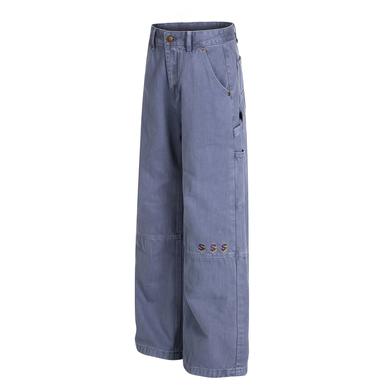 Angled front view of blue carpenter pants with side utility pockets and wide legs