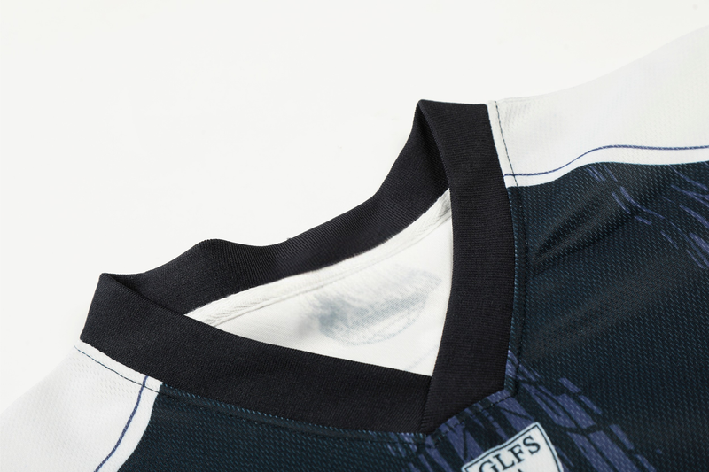 Close-up of a black and white mesh soccer jersey with striped trim and Seakoff 77 graphic details