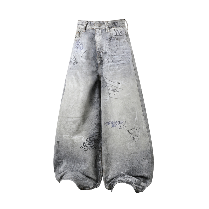 Front view of gray washed wide-leg denim pants with graffiti-style scribbles and oversized fit